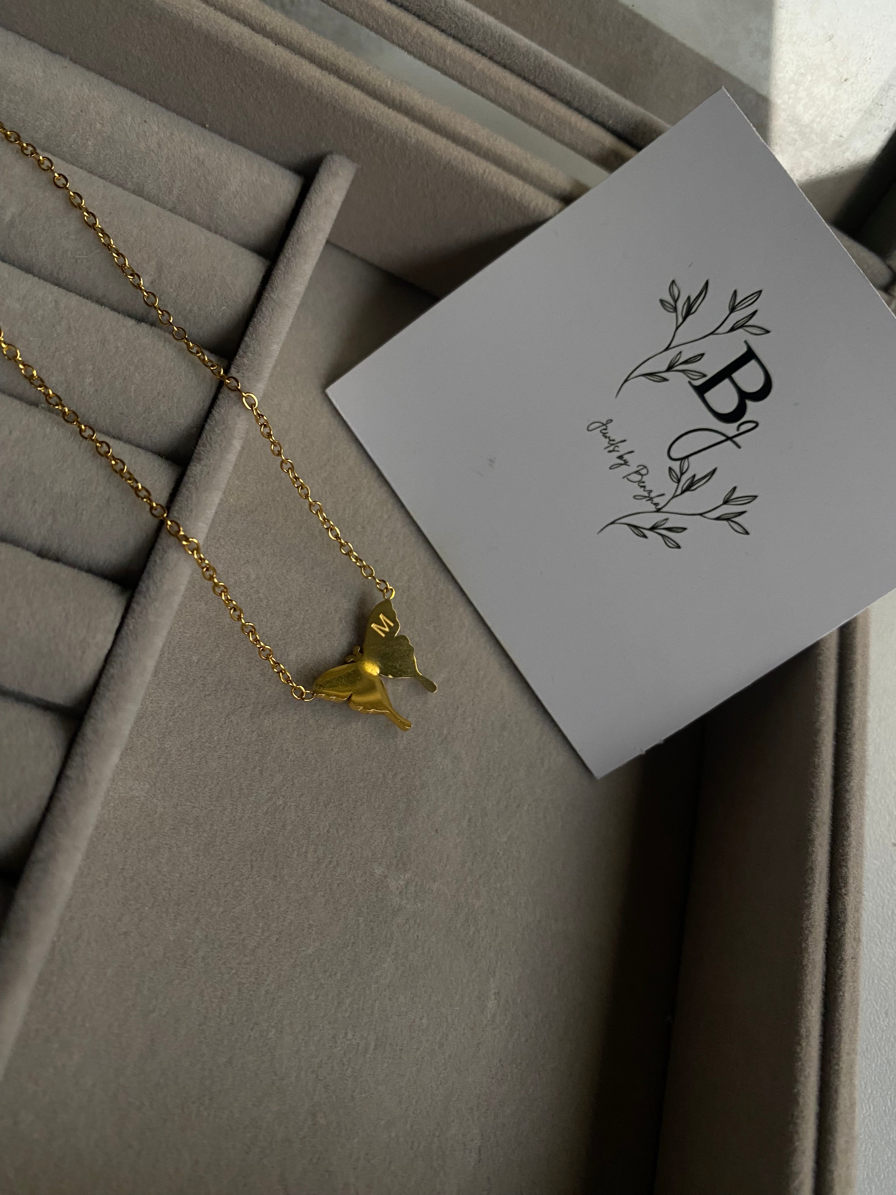 Butterfly with (letter M) locket
