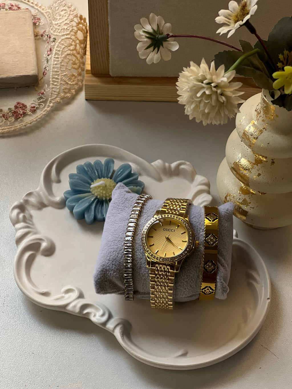 Golden watch stack with handcuff and bracelet