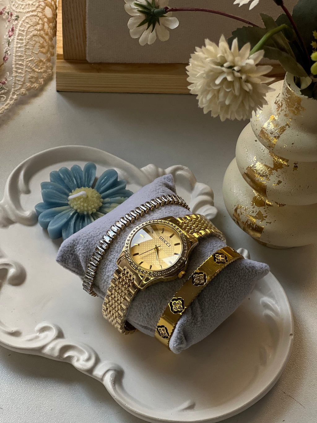 Golden watch stack with handcuff and bracelet